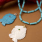 Mother-of-Pearl Fish Pendant with Green Gemstone Accent